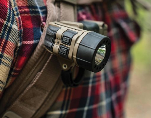 TORQ tactical flashlight on a backpack strap.